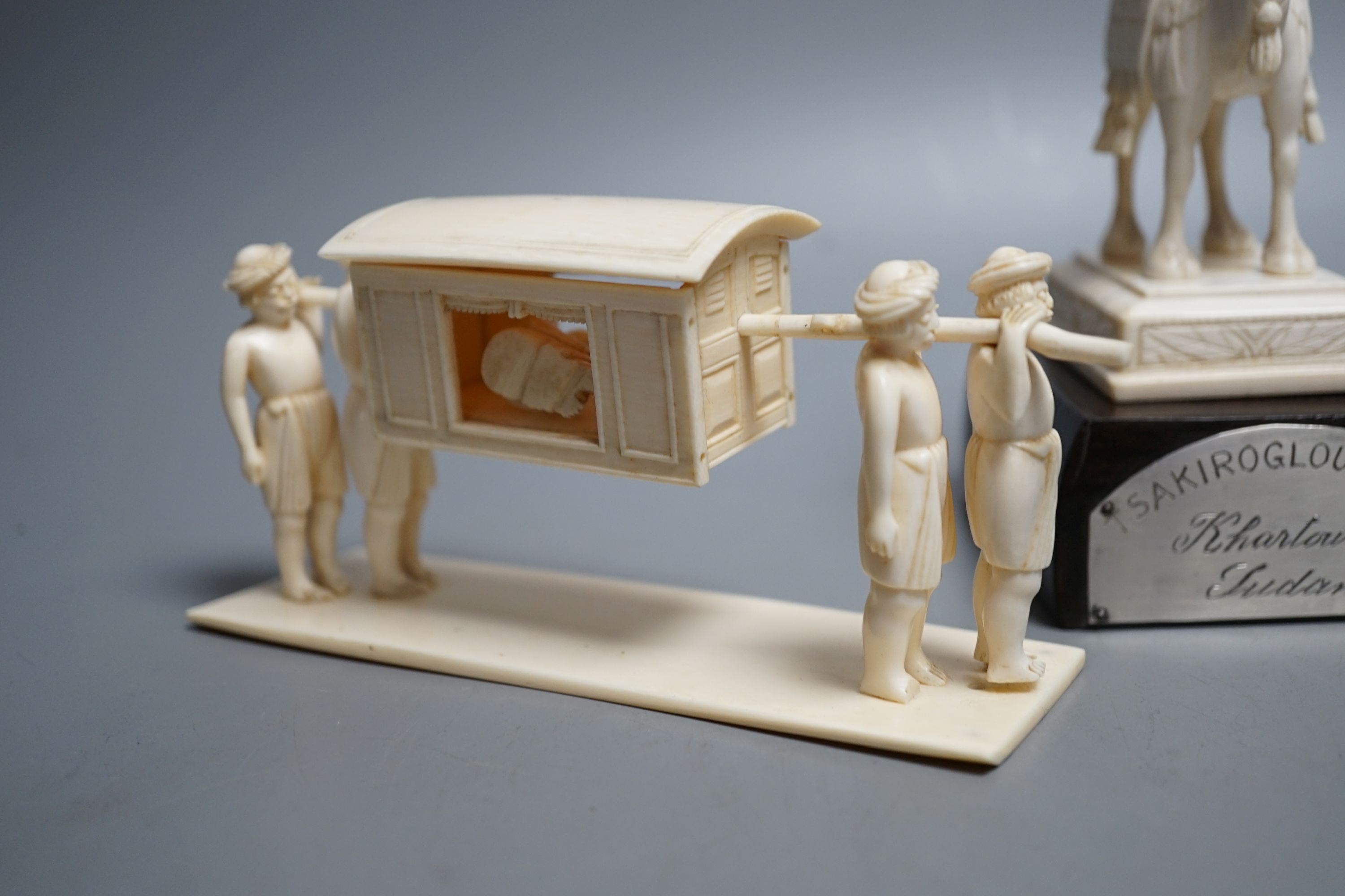 An Indian ivory sedan chair, an ivory horse and an ivory man on camel (General Gordon) with white metal plaque, 19th/early 20th century , Ivory carving of a man on a camel 14.5cms high.